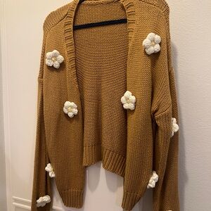 Brown cardigan with white crocheted flowers
